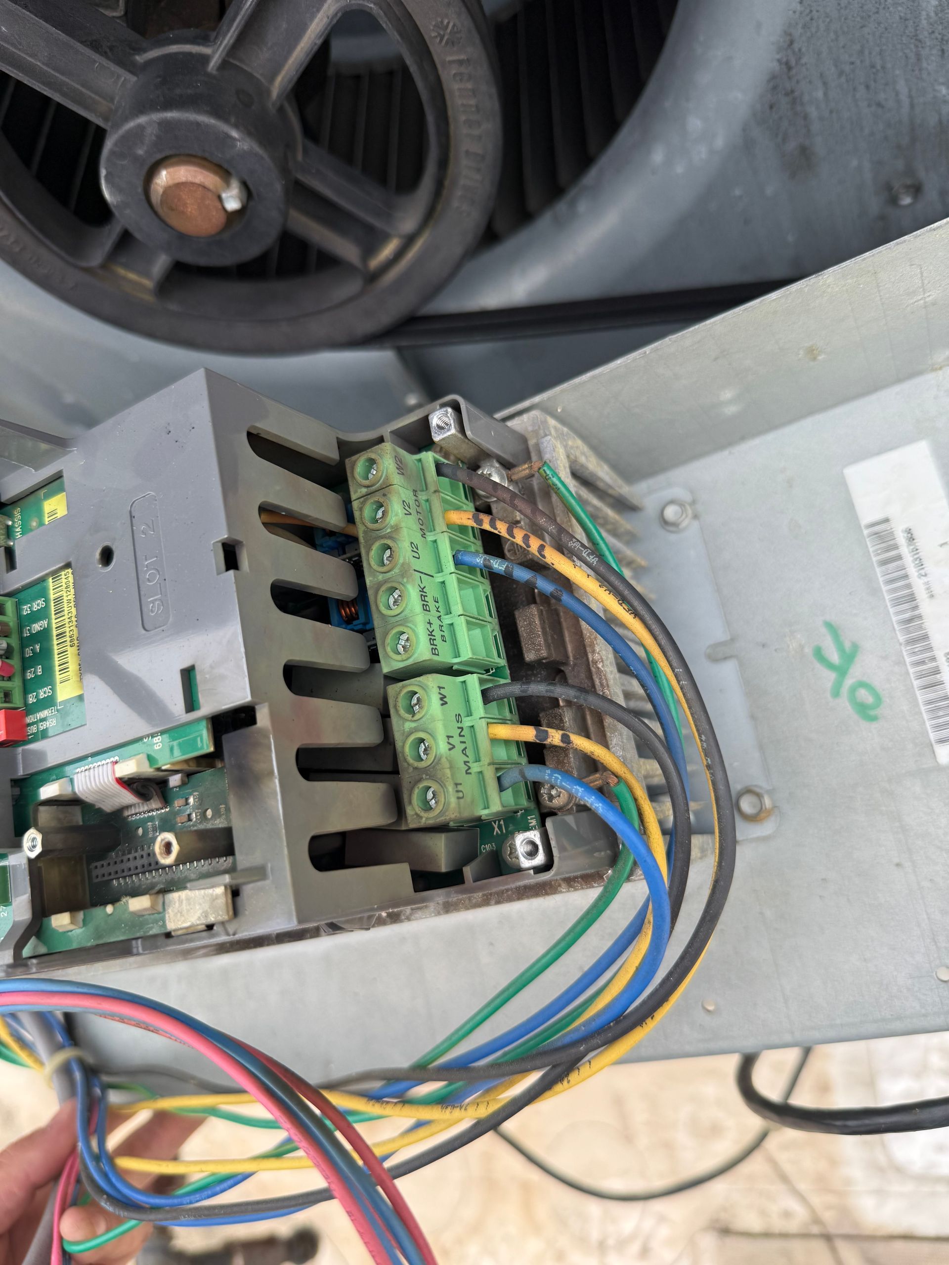 Close-up of HVAC control panel with wiring and terminal block, showing some burnt connections.