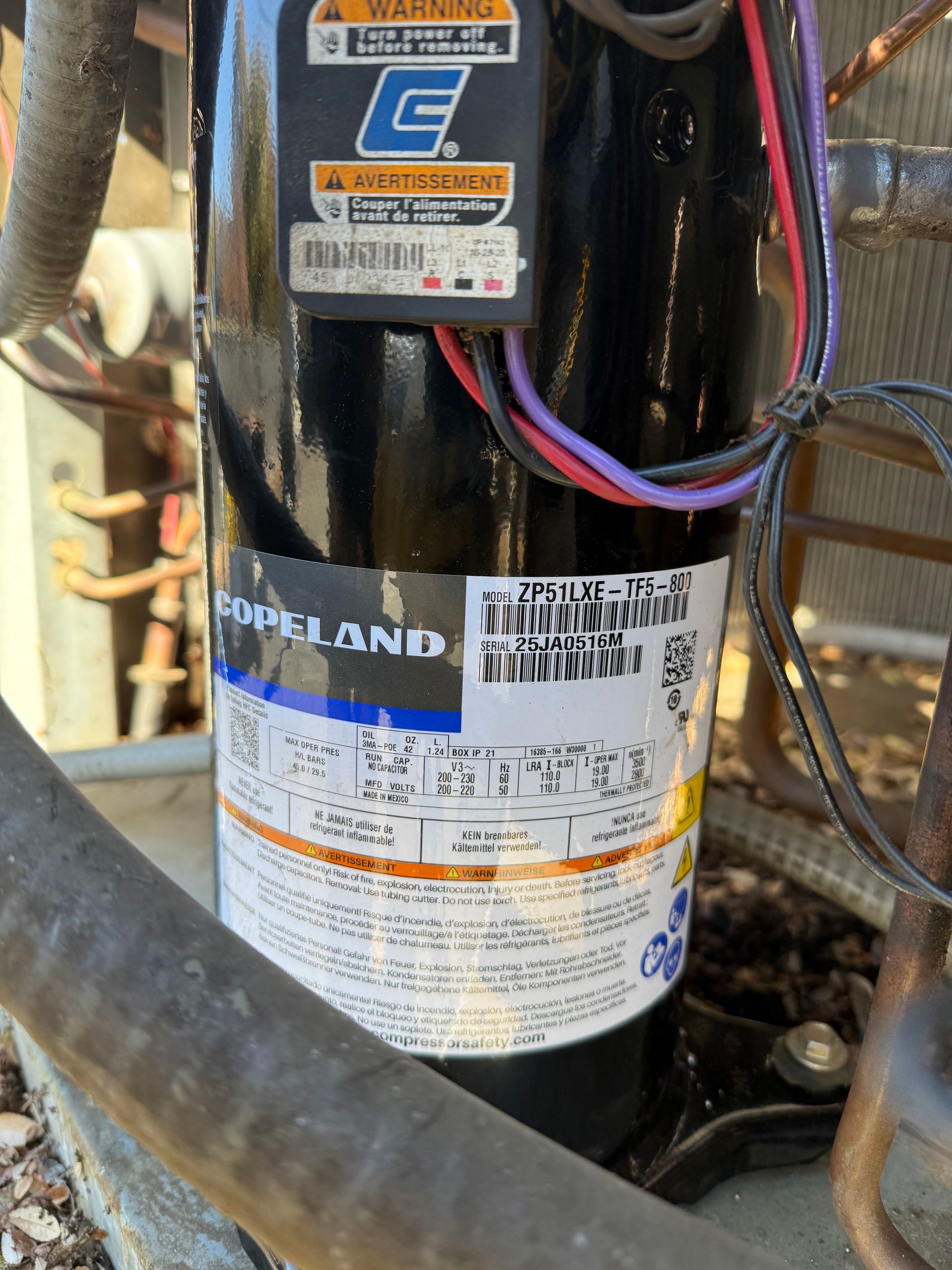 Black Copeland compressor with label and wiring.