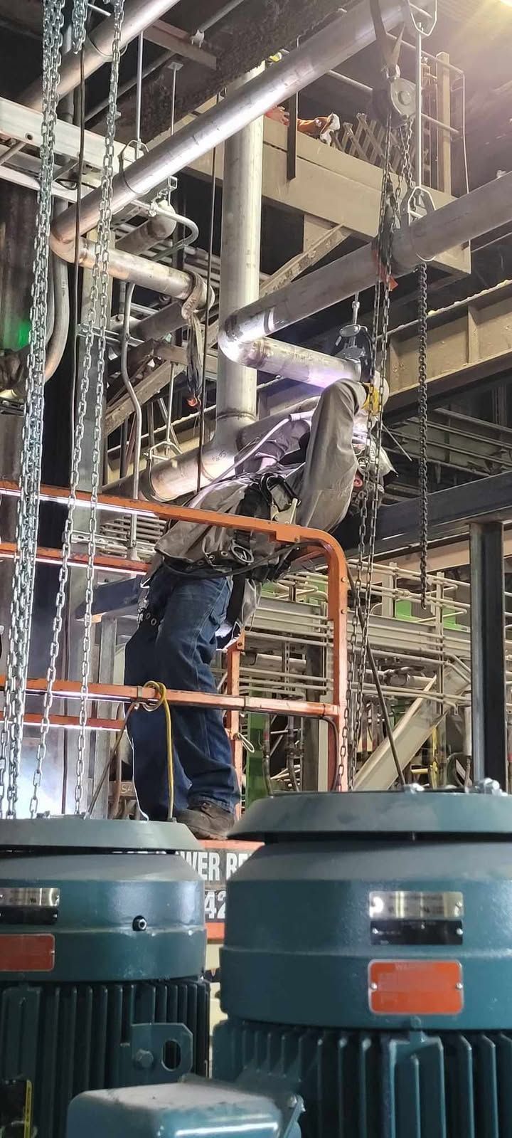 A man is working on a machine in a factory.