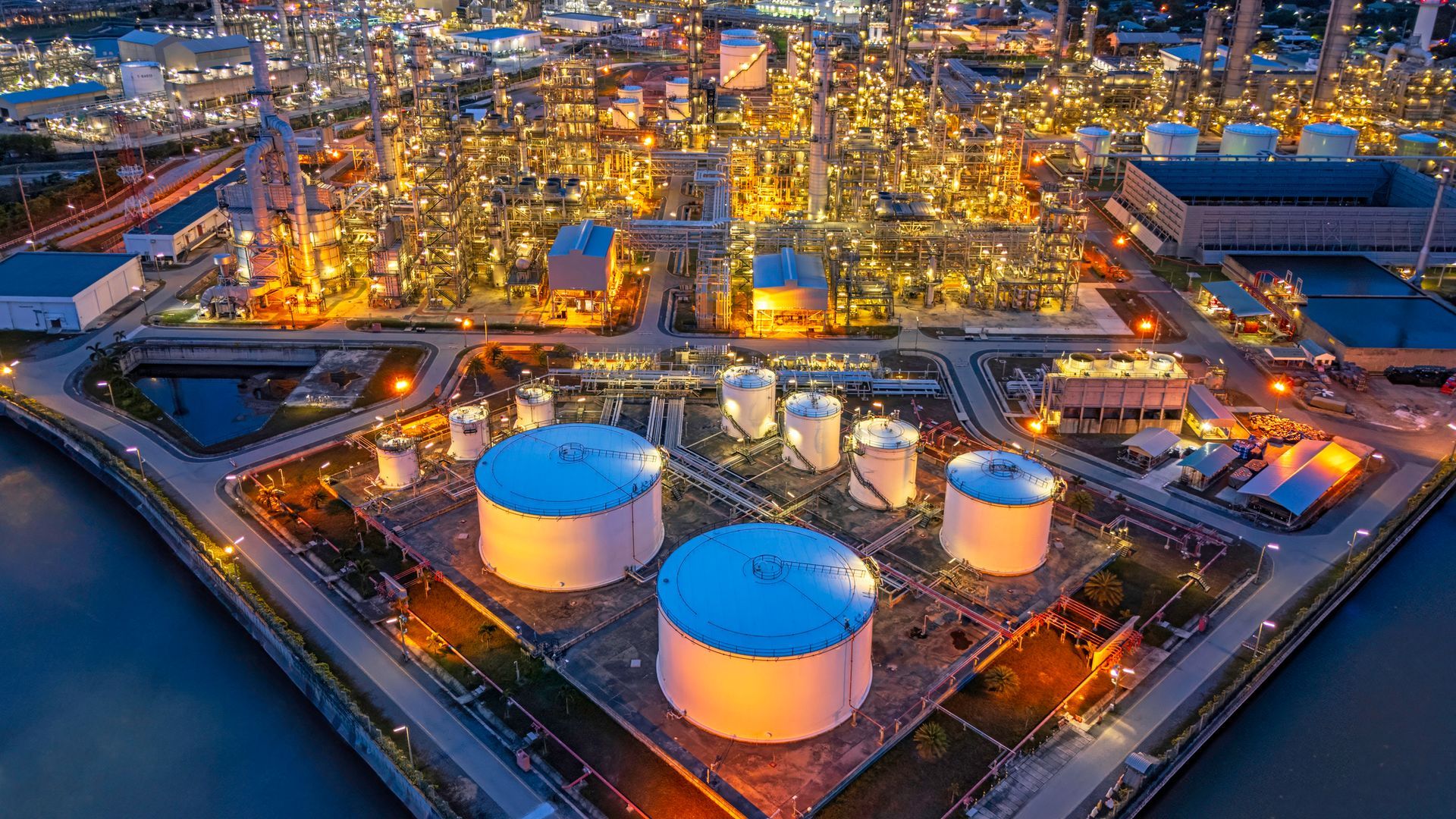 An aerial view of a large oil refinery at night.