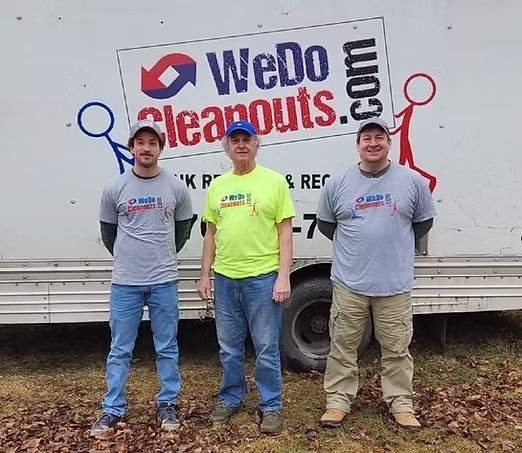 Three men standing in front of a 