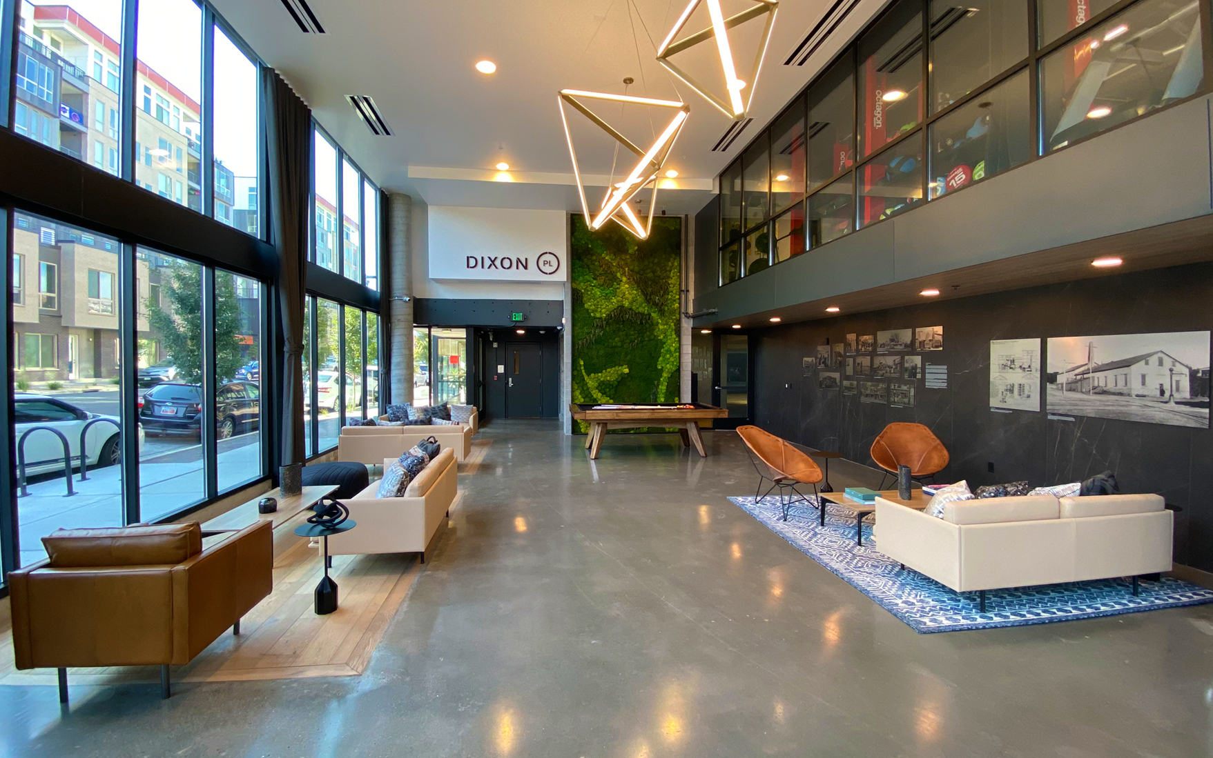 A large lobby with lots of furniture and a pool table.