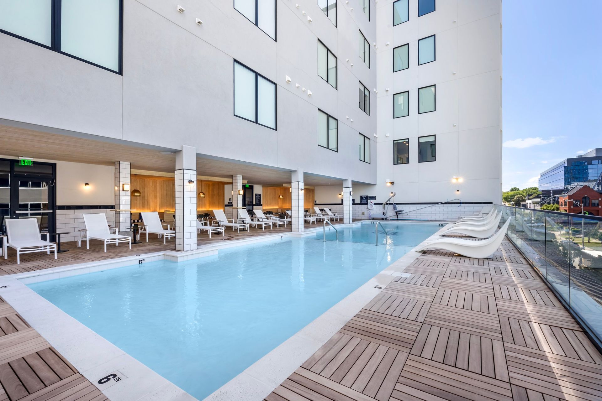 There is a large swimming pool in the middle of a building.