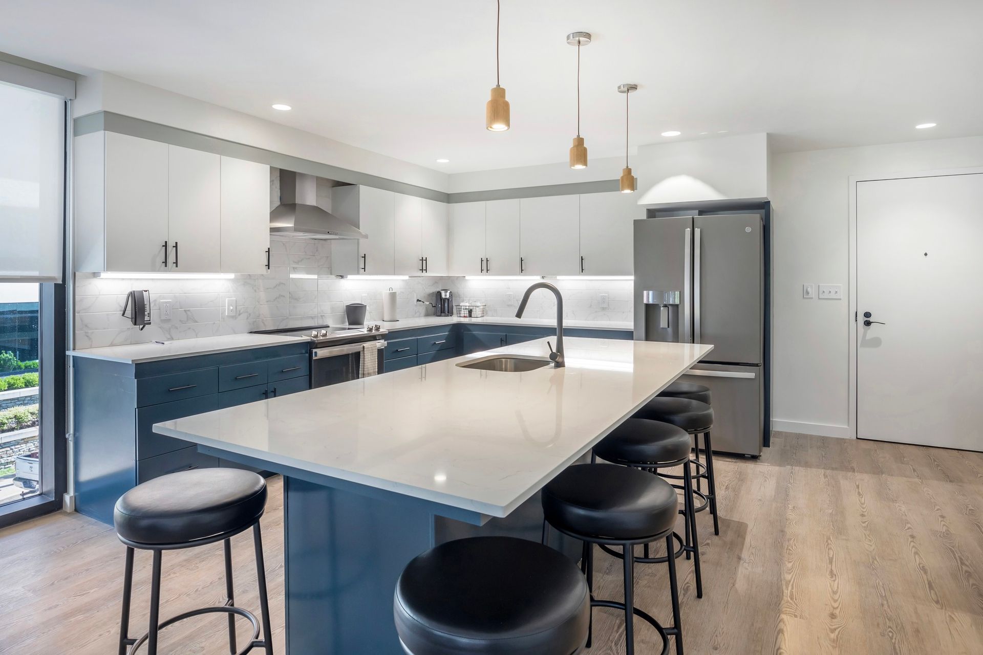 A kitchen with a large island and stools