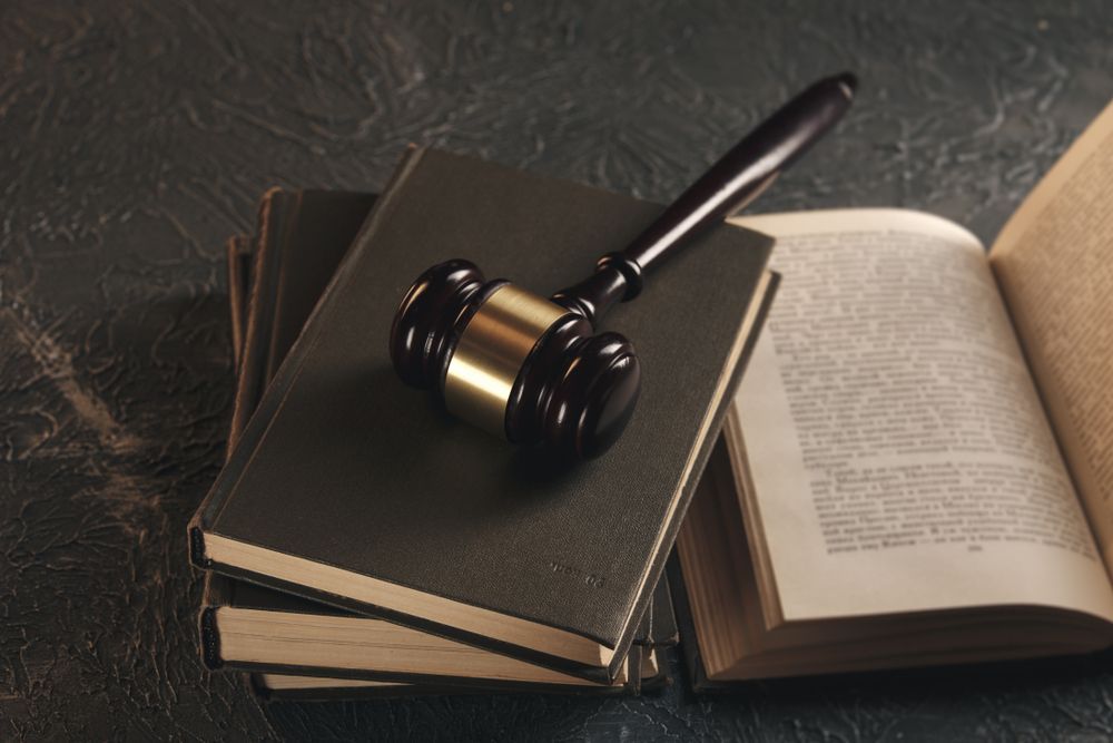 A Judge's Gavel Is Sitting On Top Of A Stack Of Books — Spencer Lawyers In Gosford, NSW