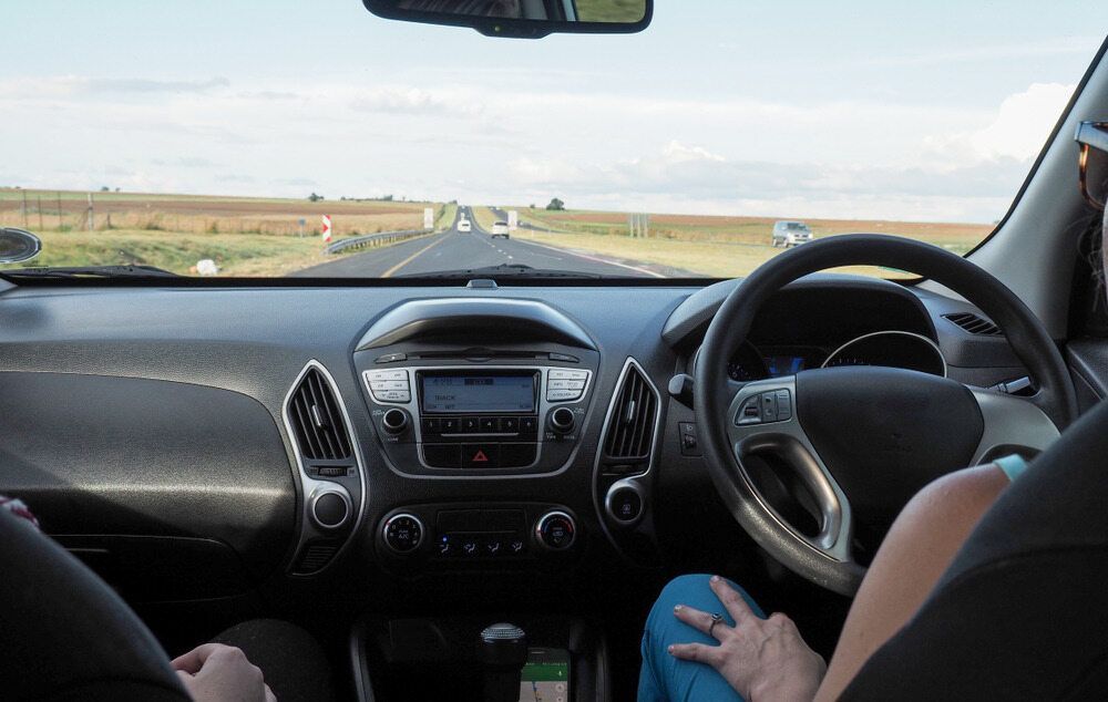 A Woman Is Sitting In The Driver 's Seat Of A Car — Spencer Lawyers In Gosford, NSW