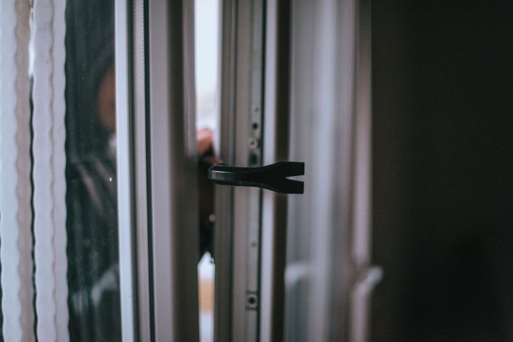 A Man Is Locking A Door With A Key — Spencer Lawyers In Gosford, NSW