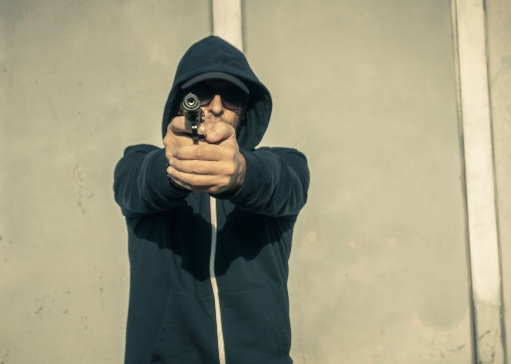 A Man Firing A Gun — Spencer Lawyers In Gosford, NSW
