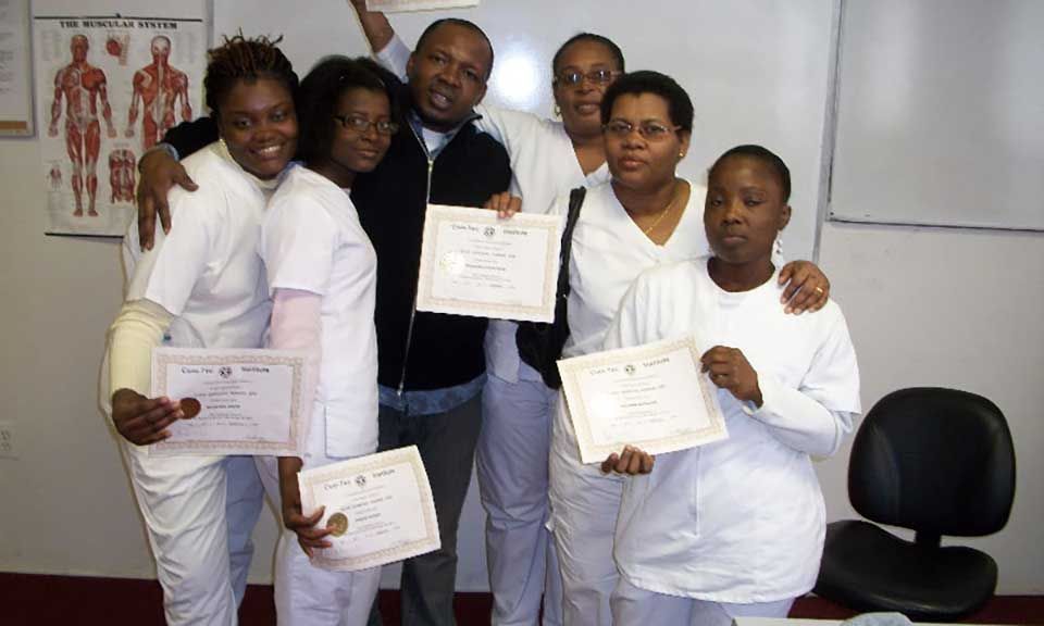 A group of people are posing for a picture while holding certificates