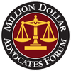 Logo for the Million Dollar Advocates Forum. A gold scale is centered on a maroon circle, surrounded by a black ring with white text.