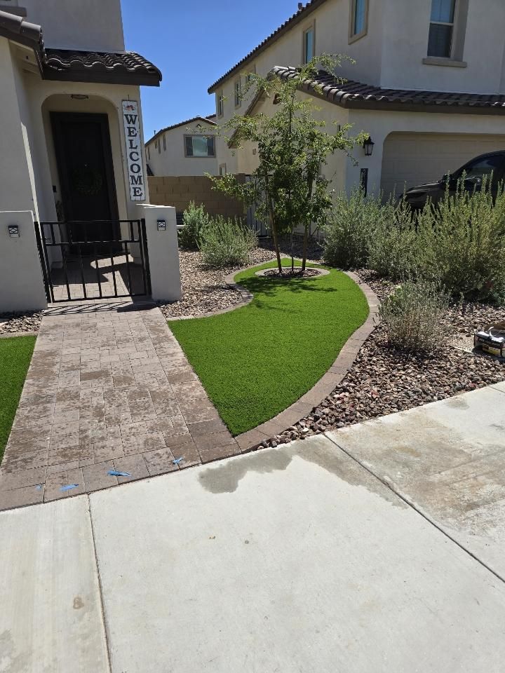 A house with a lush green lawn in front of it.
