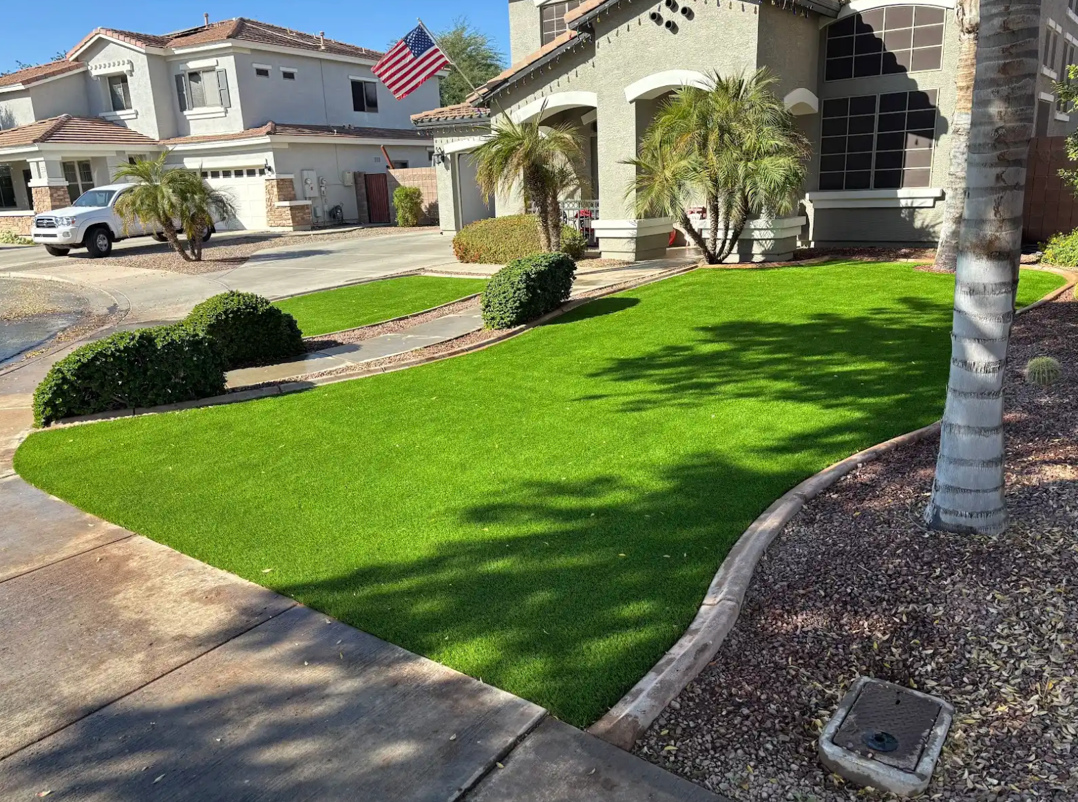 A house with a lush green lawn in front of it.