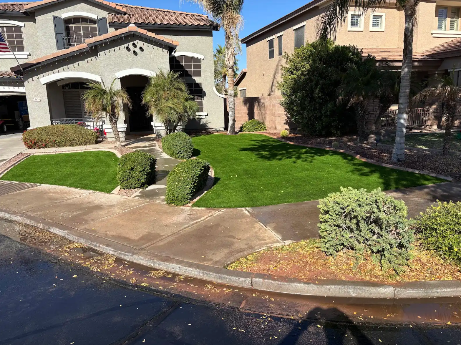 A large house with a lush green lawn in front of it.