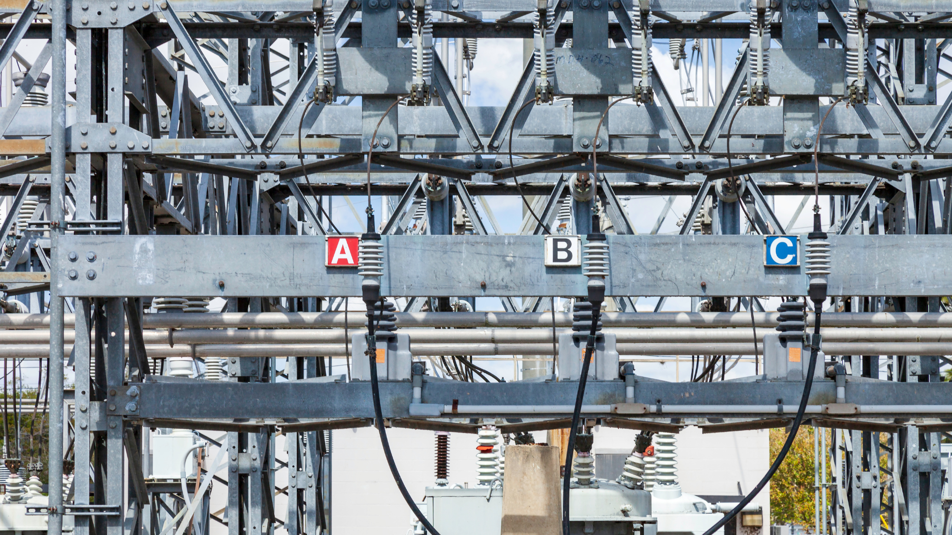 A large metal structure with a red a , b , and c sign on it.