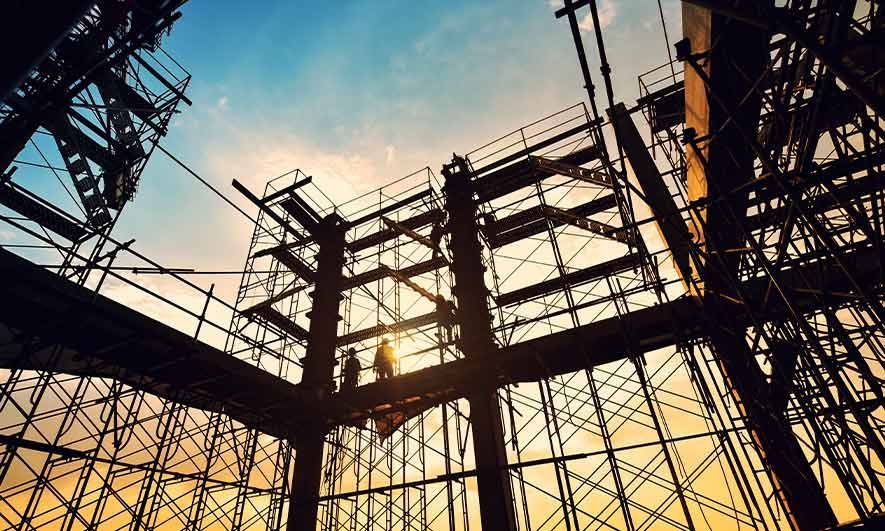 A construction site with a lot of scaffolding and workers.