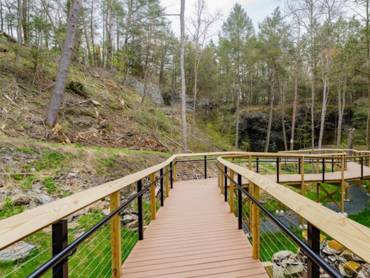 A wooden bridge build by Kobalt Construction over Marshall Falls.