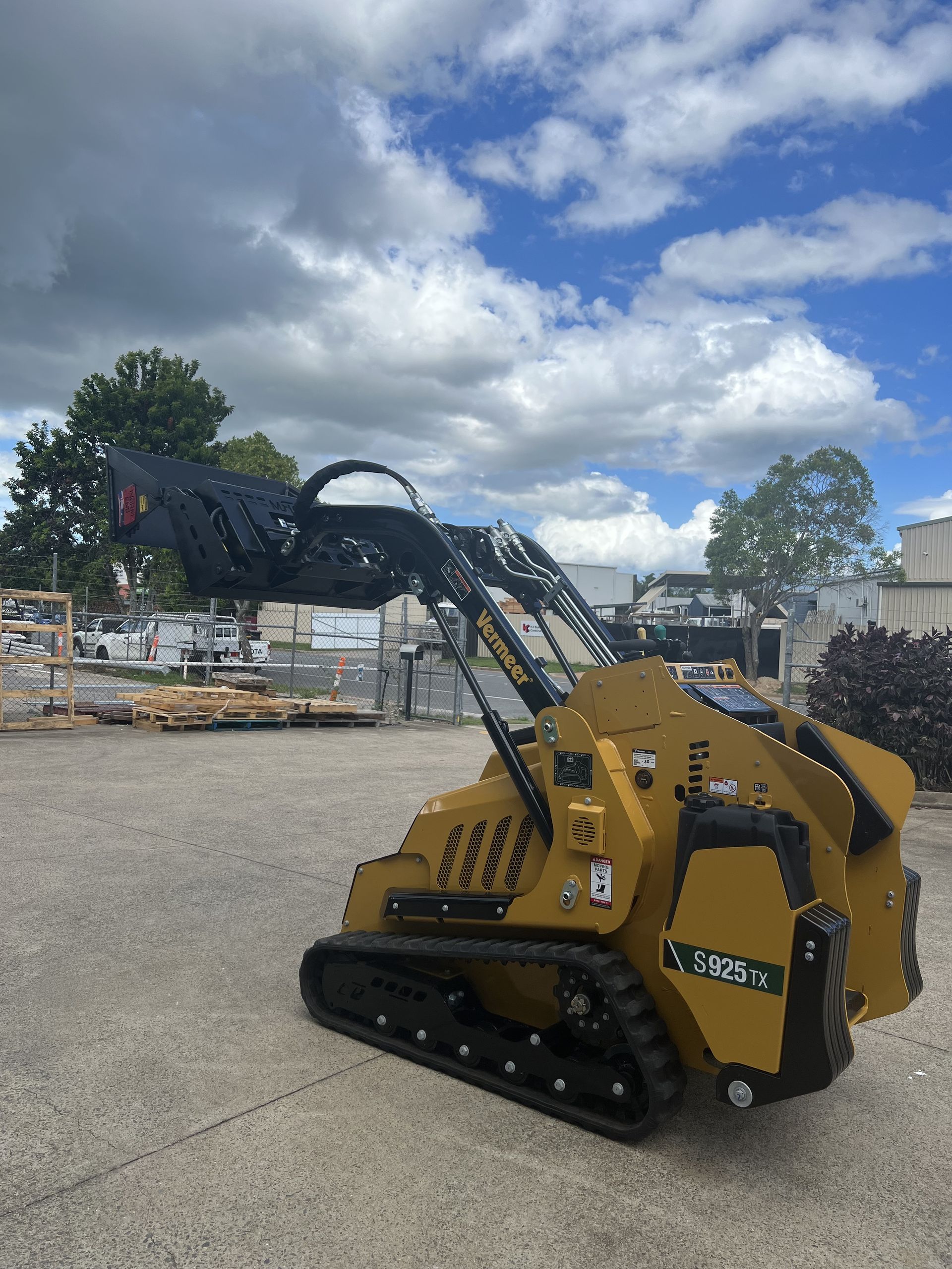 Yellow Skid Steer Loader on a Dirt Road — Excavator Machinery & Equipment Hire in Cairns, QLD