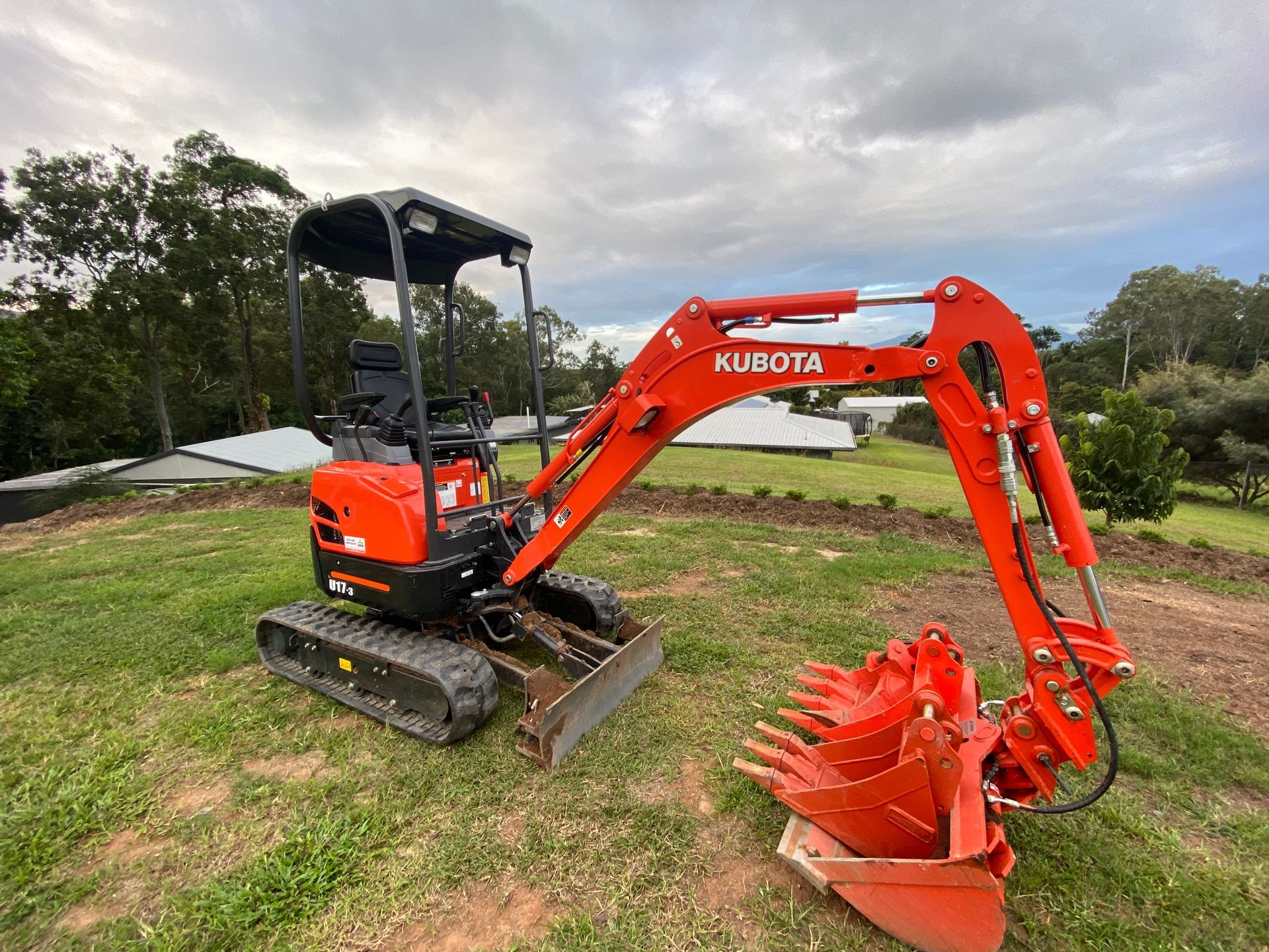 Yellow Excavator Digging a Trench at a Construction Site — Excavator Machinery & Equipment Hire in Cairns, QLD