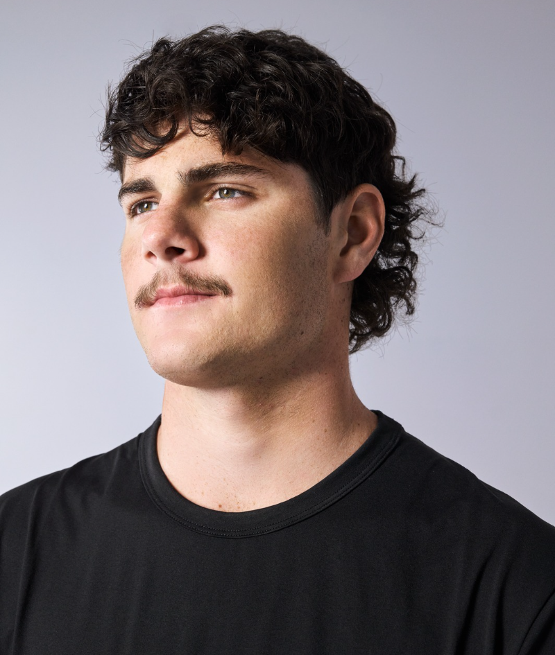 Close up side profile studio portrait of Jack who wears a black Nike t-shirt.