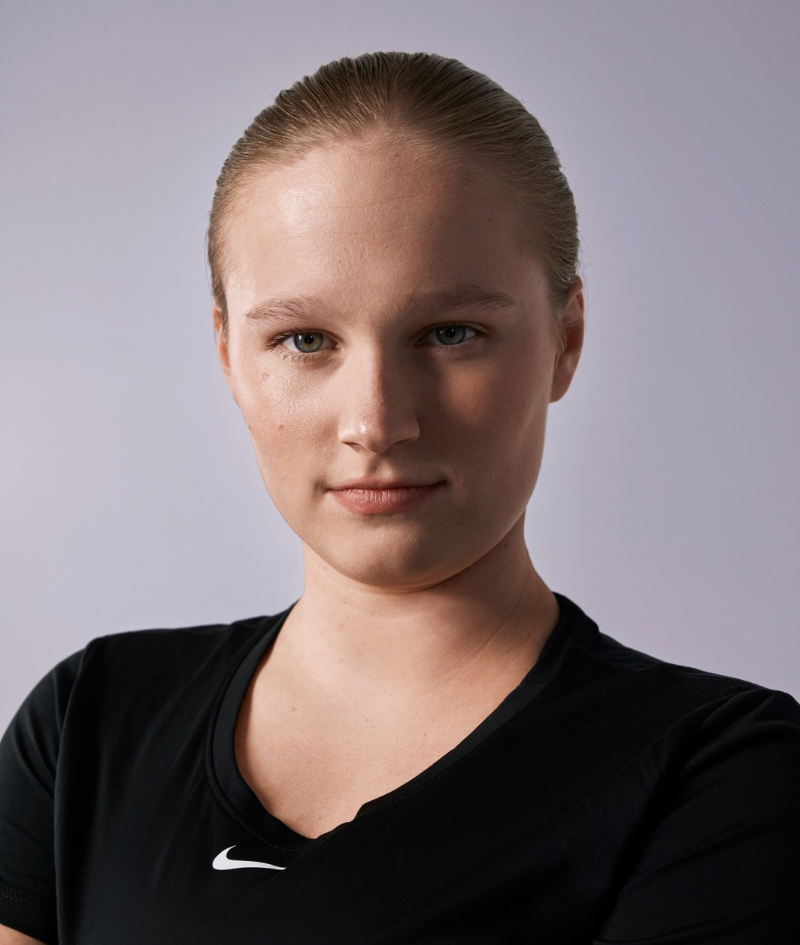 Close up studio portrait of Holly who wears a black Nike t-shirt.