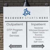 Sign for a recovery center with outpatient and inpatient services.