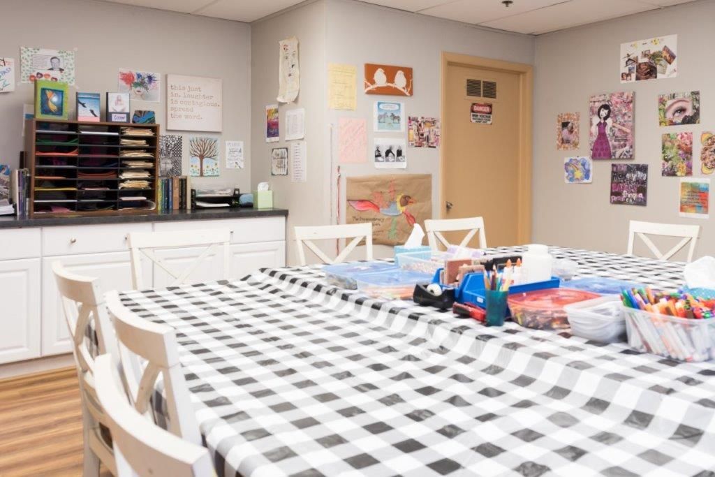 Art room with a large table, decorated with artwork.