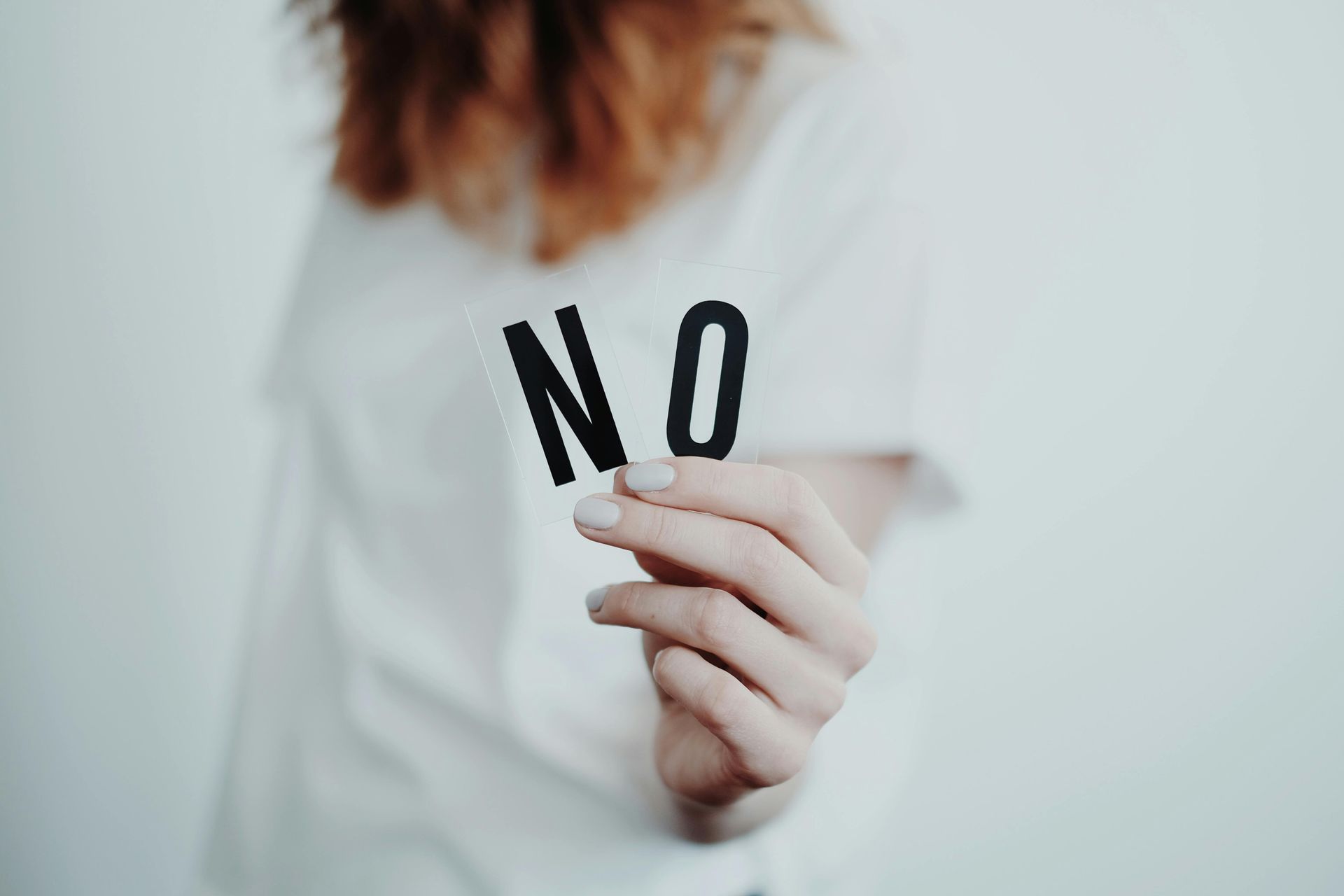 Person holding a piece of paper with the word 