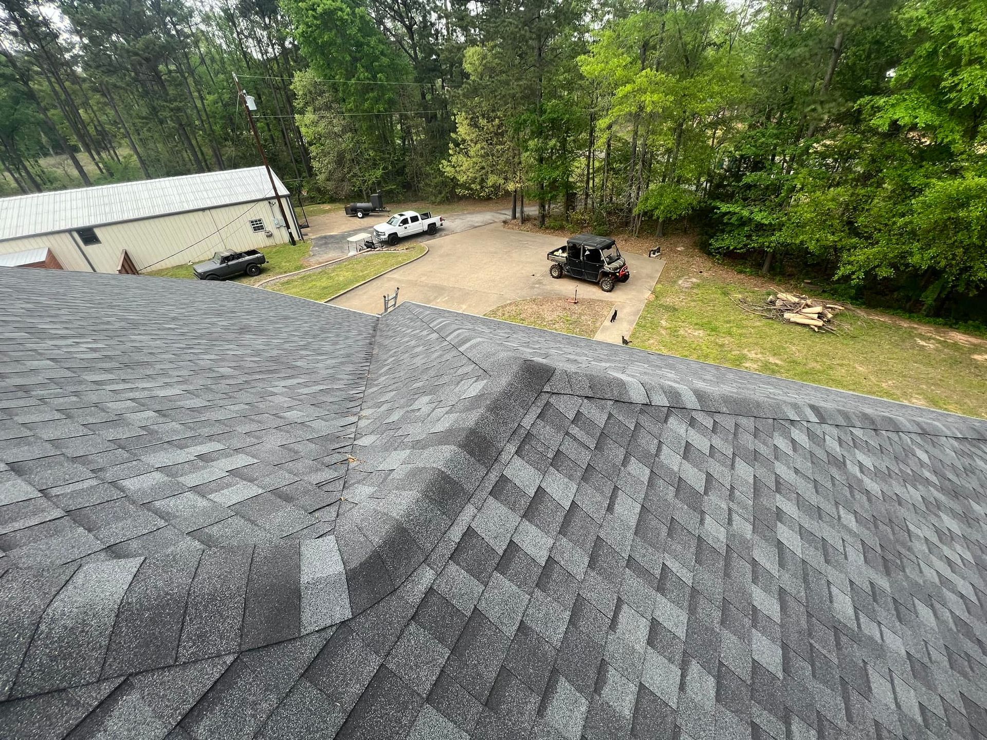 An aerial view of a roof with a car parked on it.