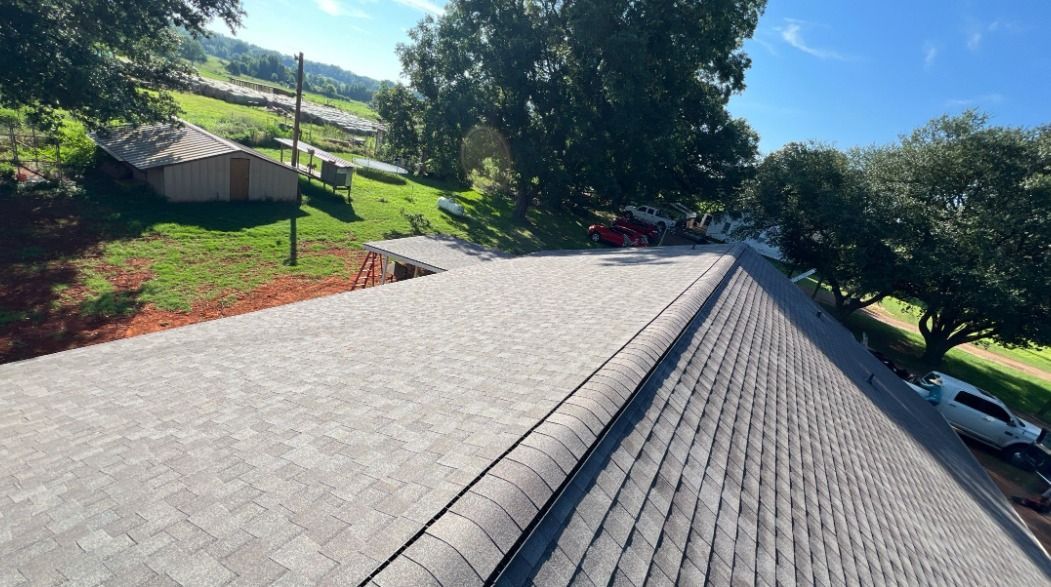 A car is parked on the side of a road next to a roof.