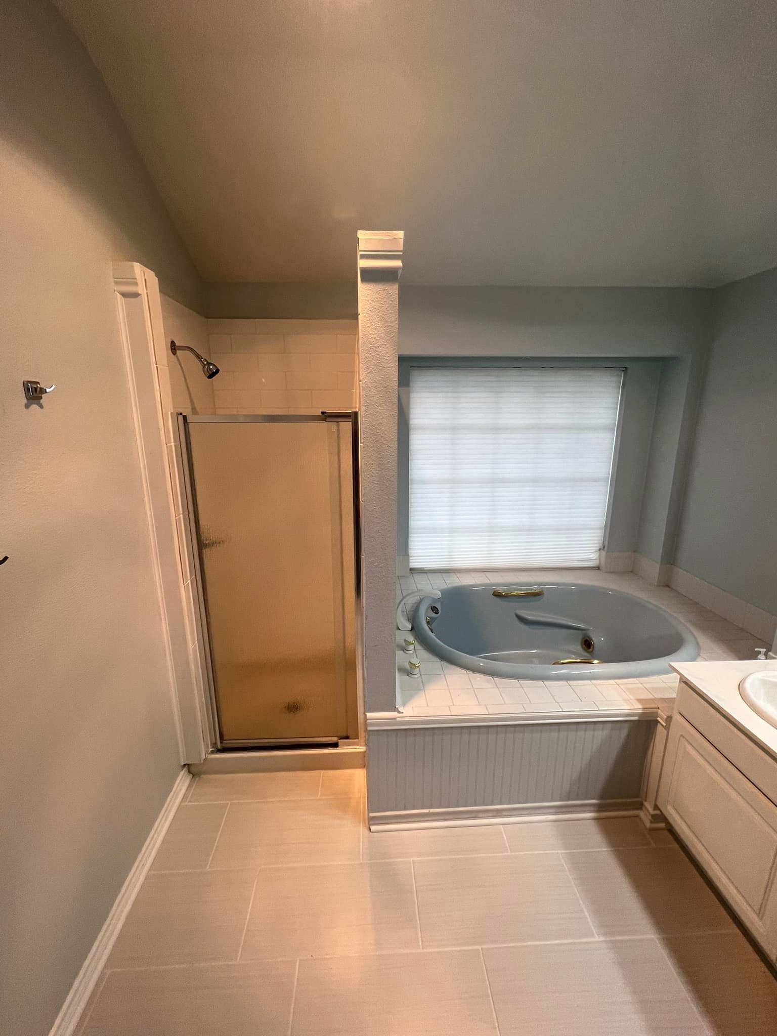A bathroom with a jacuzzi tub and a walk in shower.