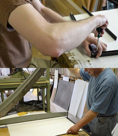 Man assembling a picture frame with a screwdriver. Another man uses a machine to cut paper for framing.