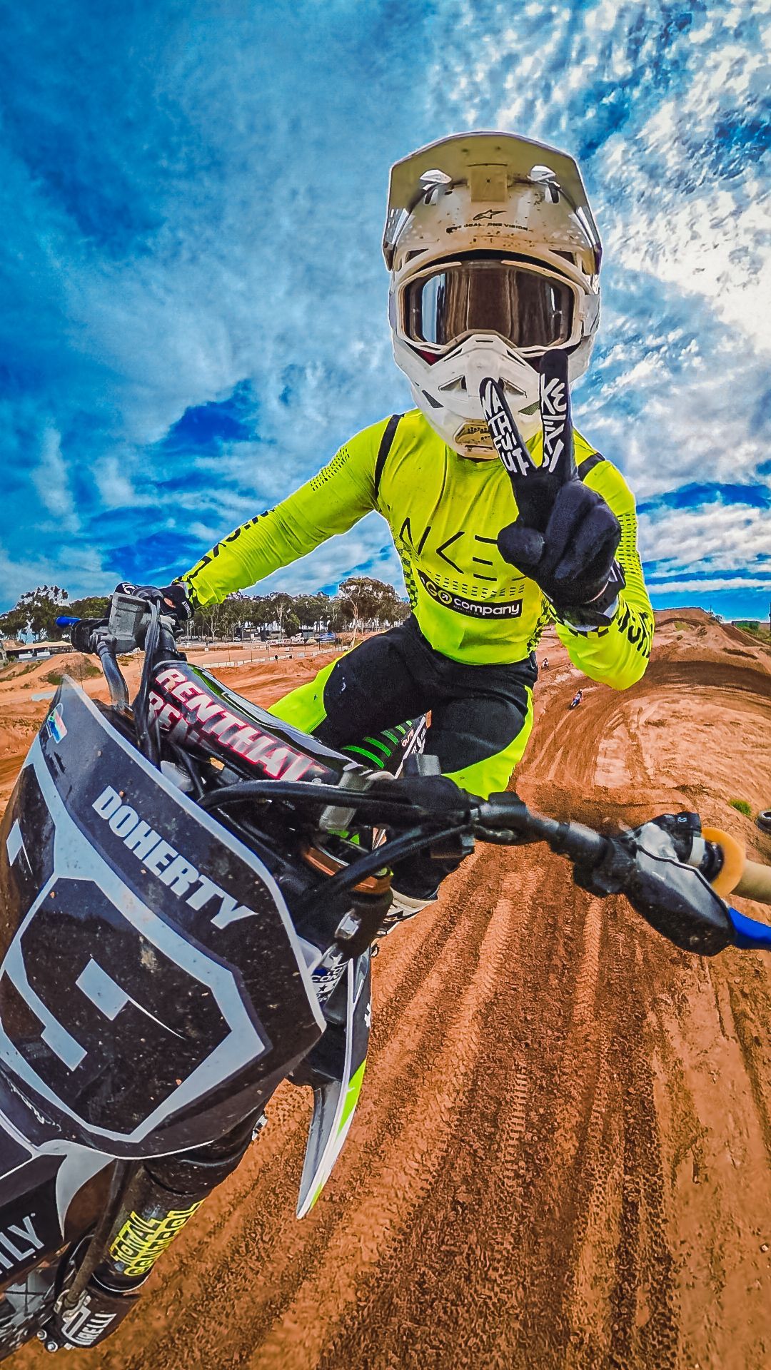 A person is riding a dirt bike on a dirt track.