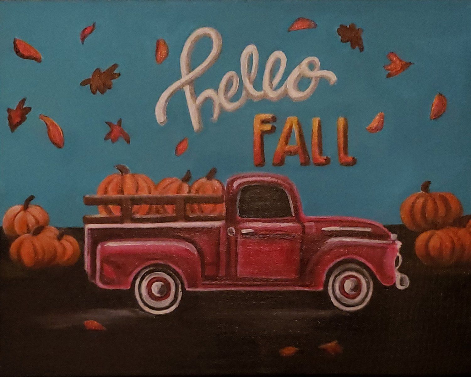 A red truck with pumpkins in the back says hello fall