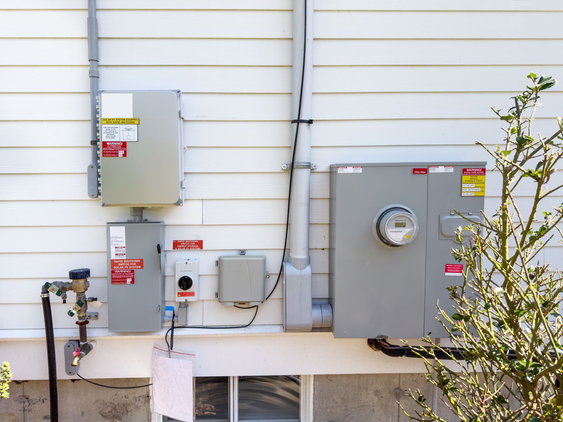 Image existing power entrance boxes that have been relocated on the exterior of a residential home