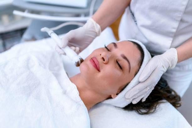 A woman is getting a facial treatment in a beauty salon.