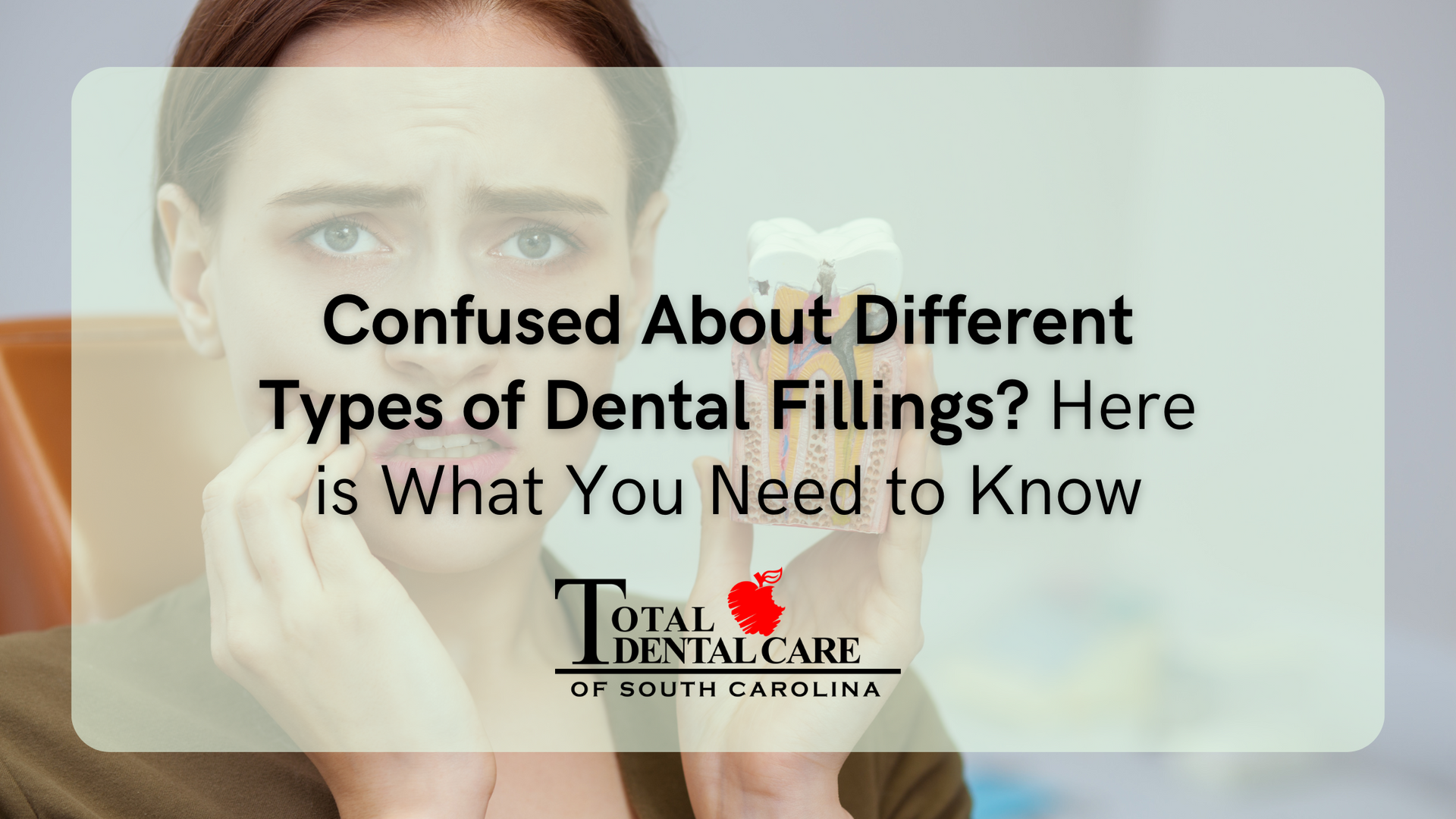 A woman is holding a tooth in her hand and is confused about different types of dental fillings.