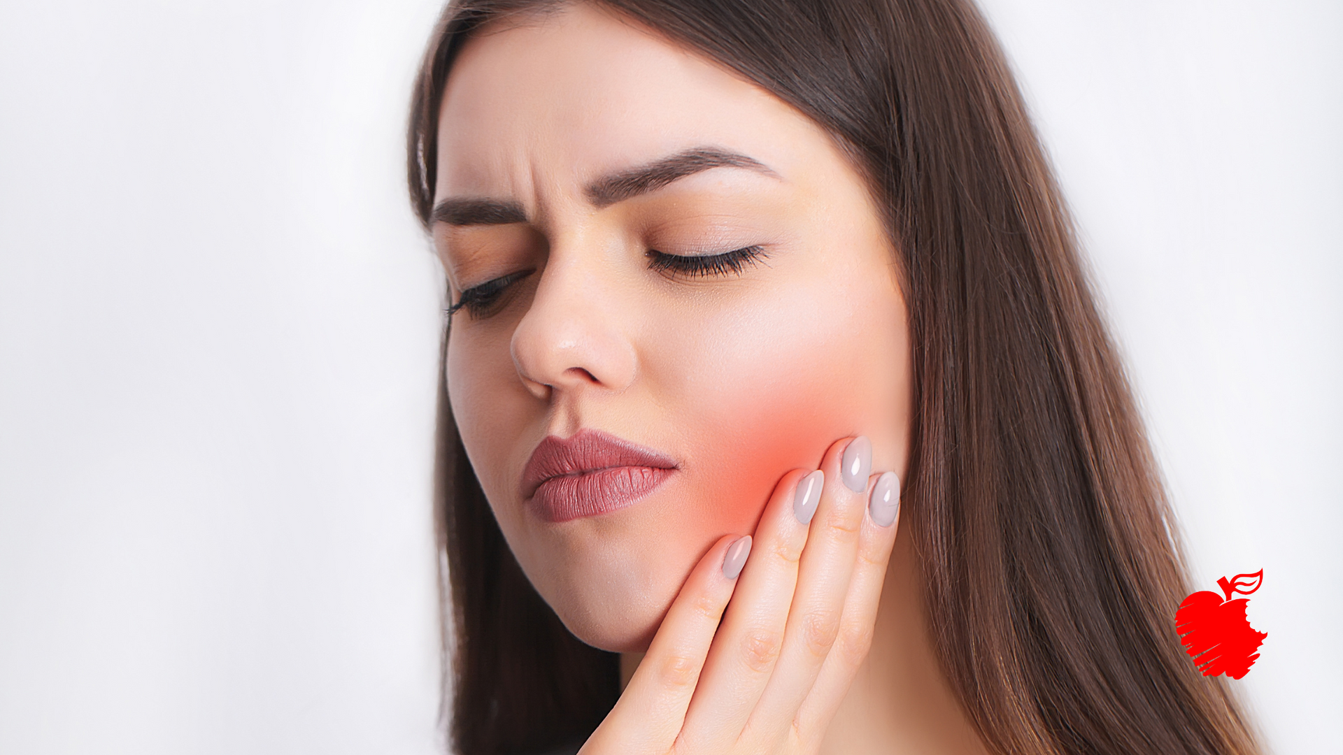 A woman is holding her face in pain because of a toothache.