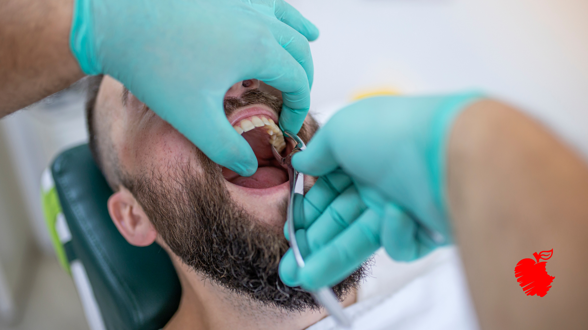 A man is getting his teeth examined by a dentist.