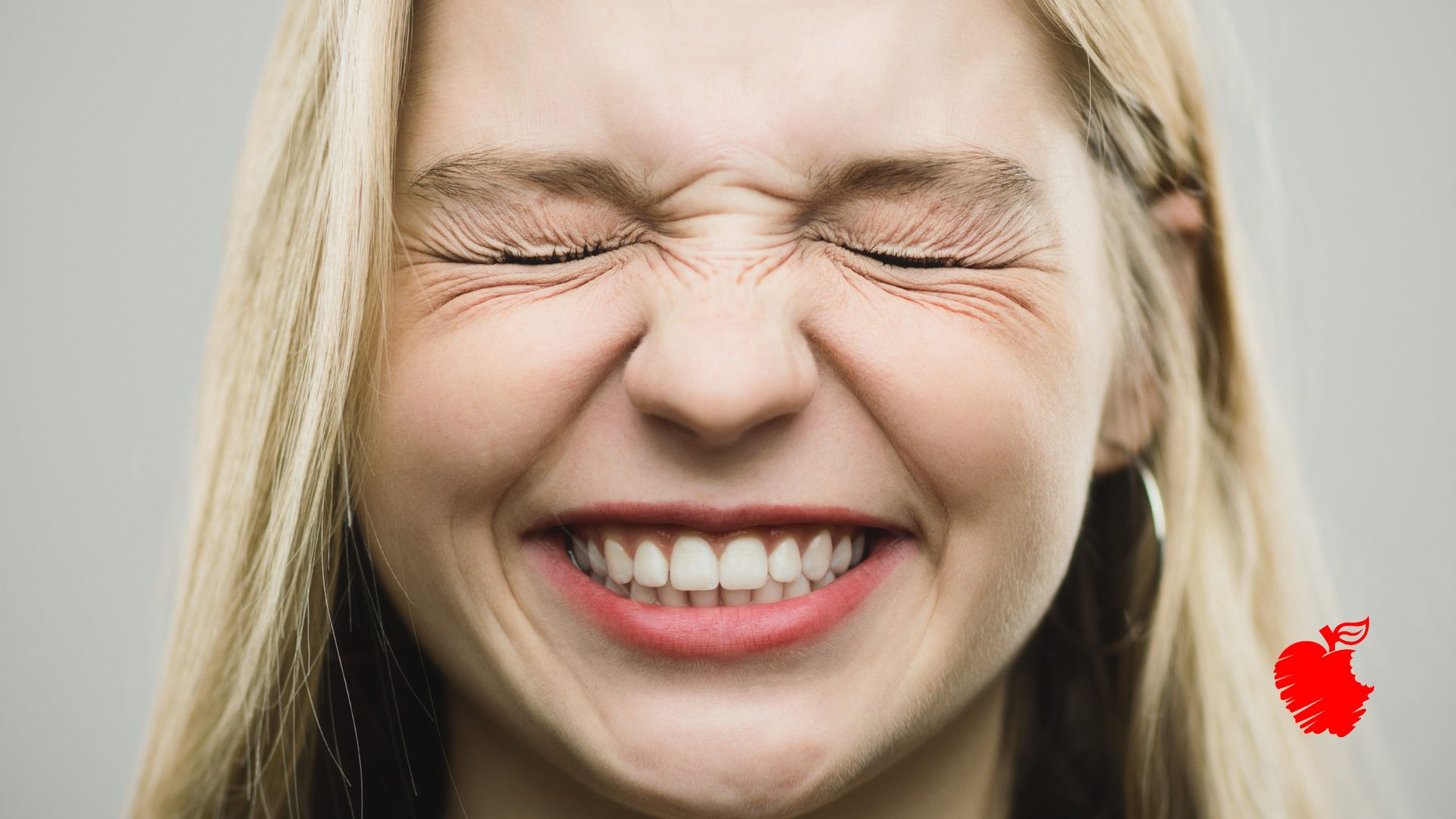 A woman is holding her face in pain because of a toothache.