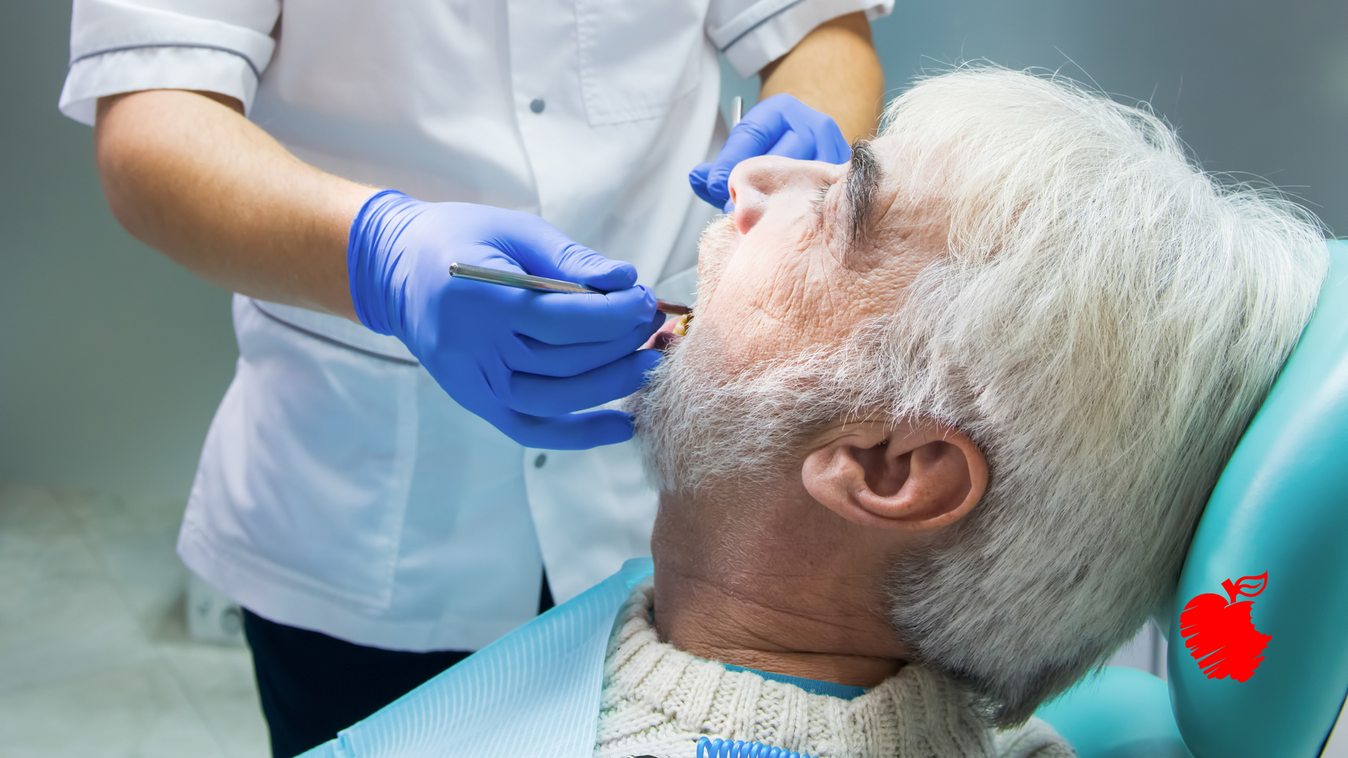 An elderly man is sitting in a dental chair getting his teeth examined by a dentist.