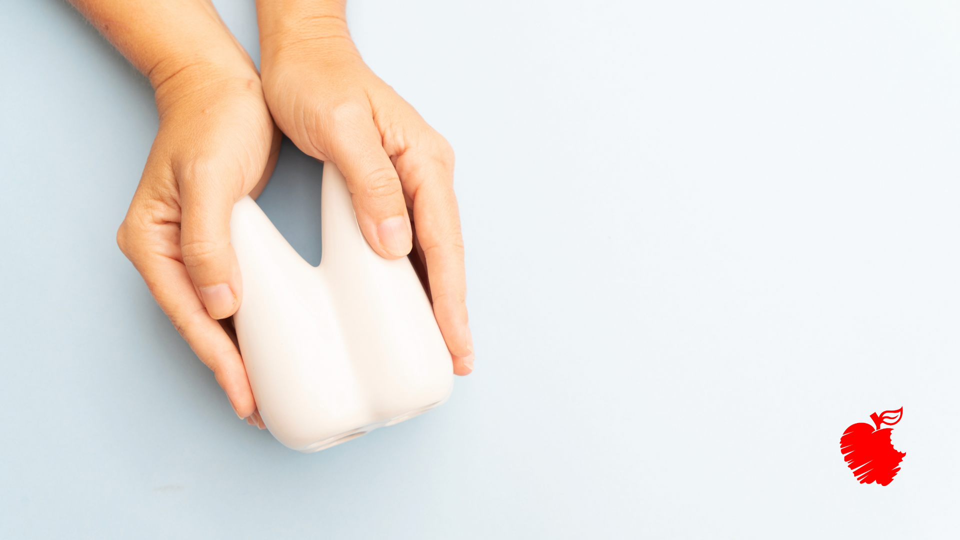 A person is holding a white object in their hands.