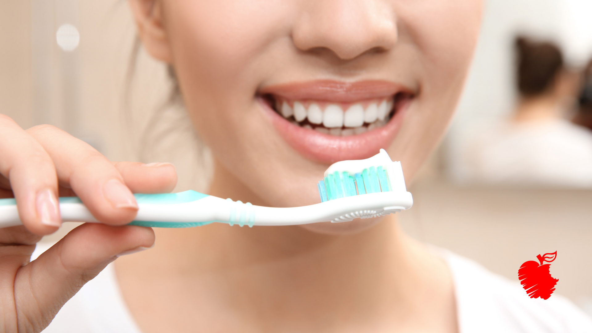 A woman is brushing her teeth with a toothbrush.