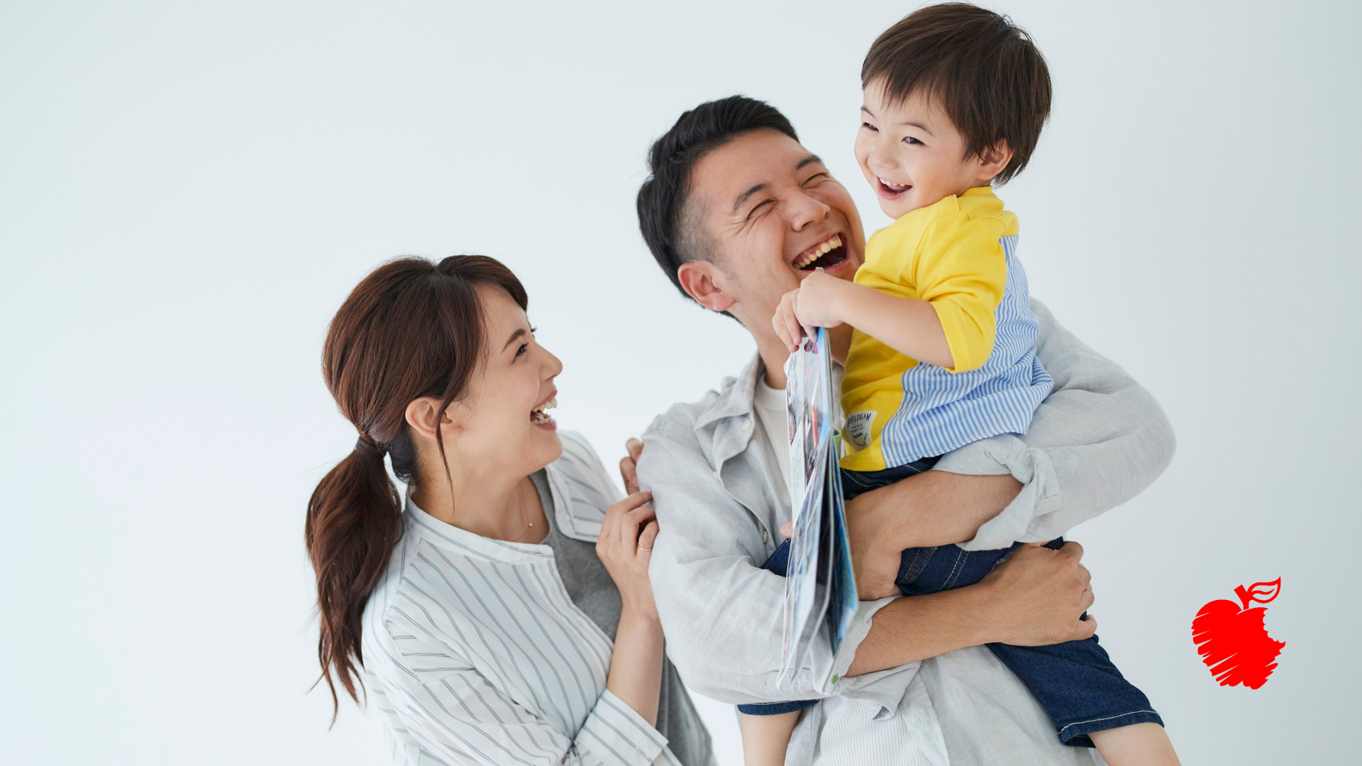 A man and woman are holding a baby in their arms.