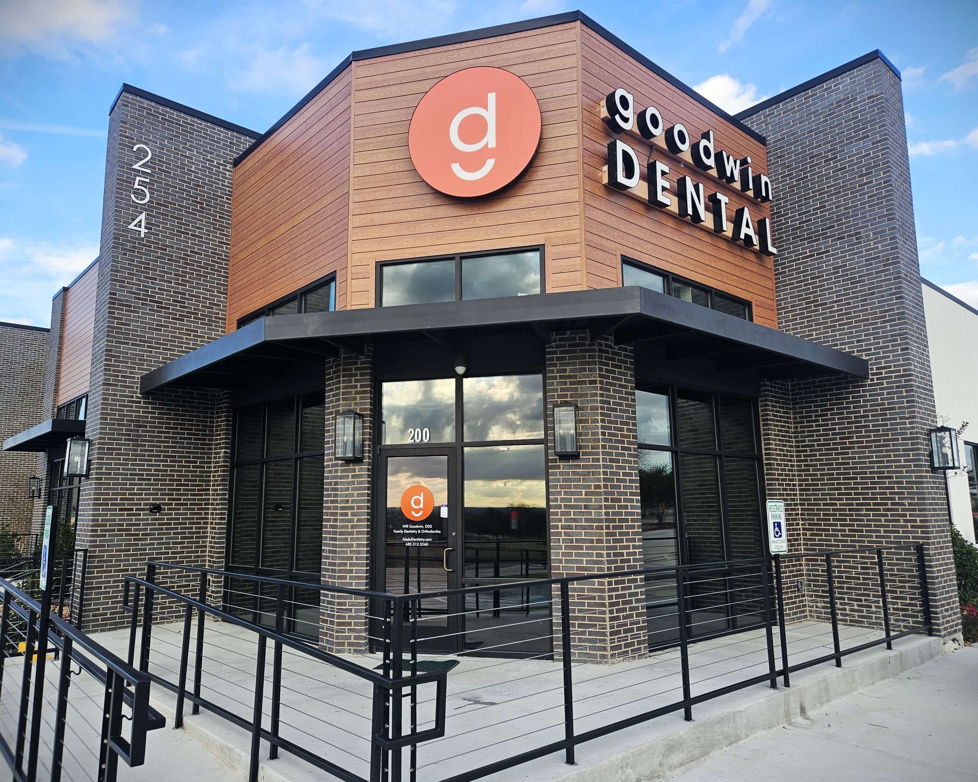 A brick building with a sign that says goodwin dental on it.