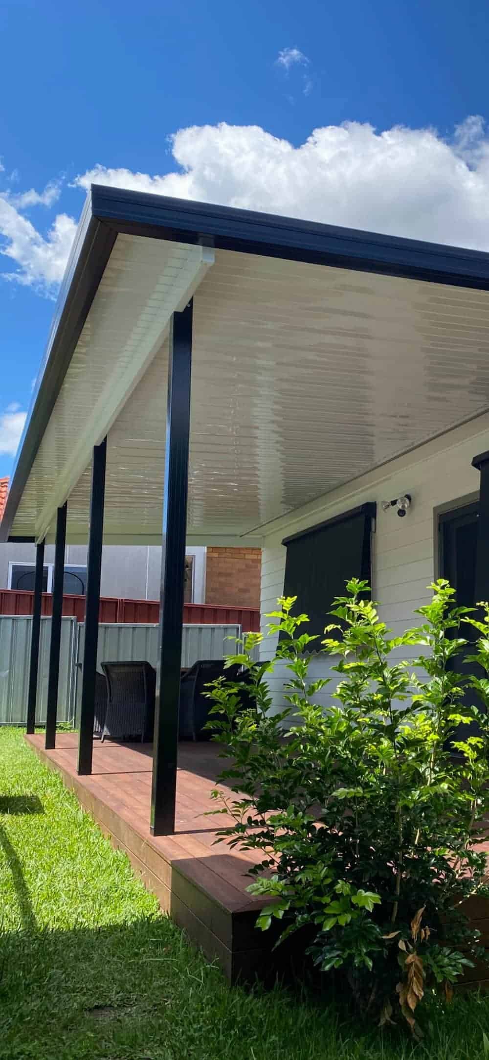 A House With A Covered Porch And A Bush In Front Of It — Newcastle Patio Covers In Wallsend, NSW