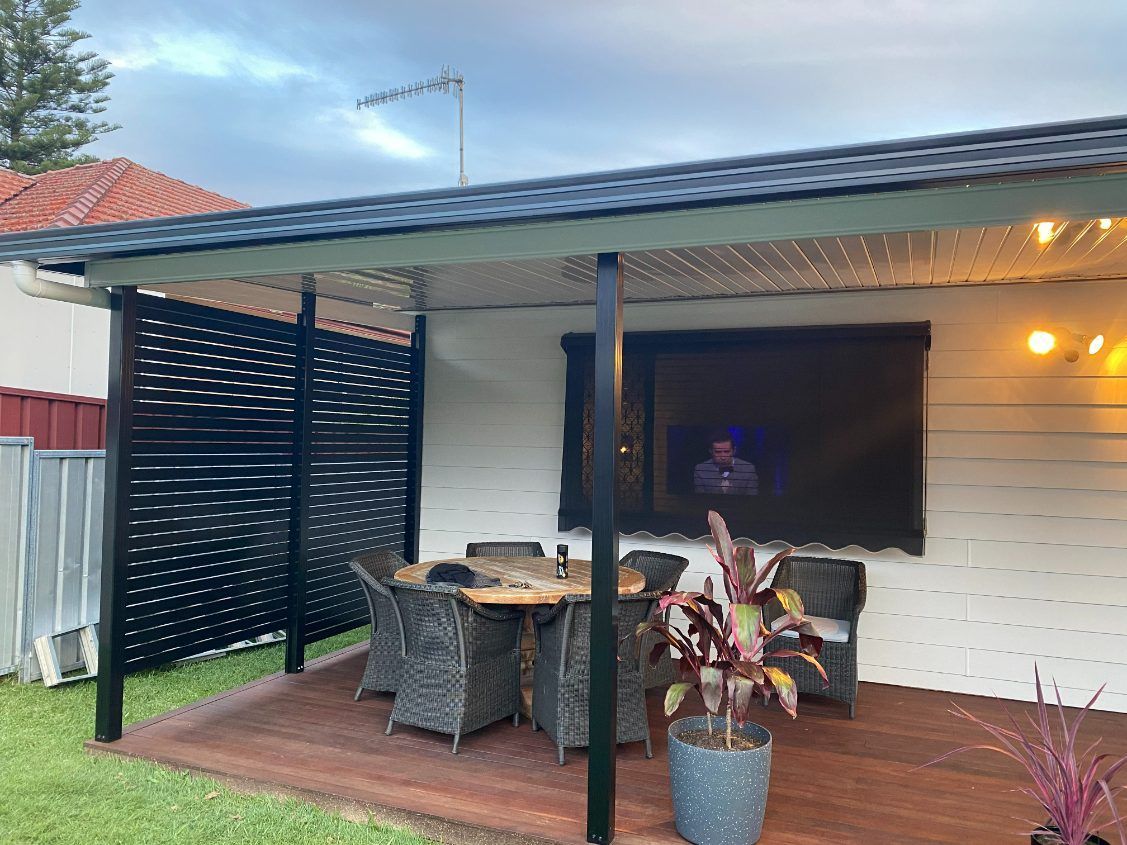 A Colourbond Patio Cover  With A Table And Chairs Under it— Newcastle Patio Covers In Wallsend, NSW