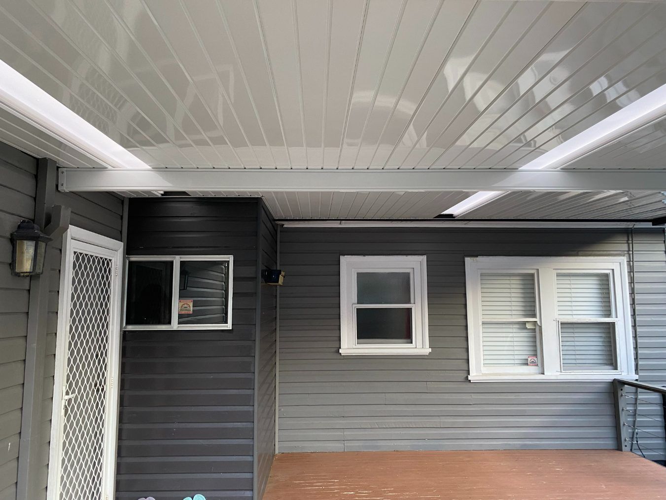 A House With A Covered Porch And A White Ceiling — Newcastle Patio Covers In Wallsend, NSW
