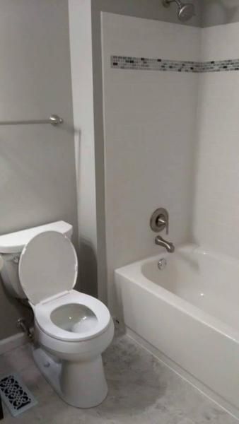 new tub and toilet in bathroom