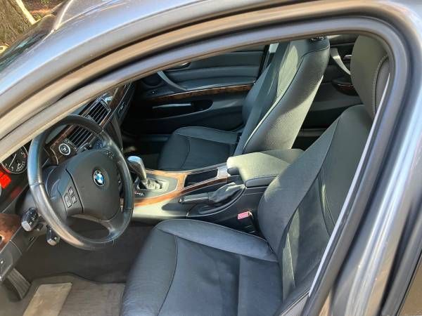 The interior of a bmw 3 series is shown with the door open.