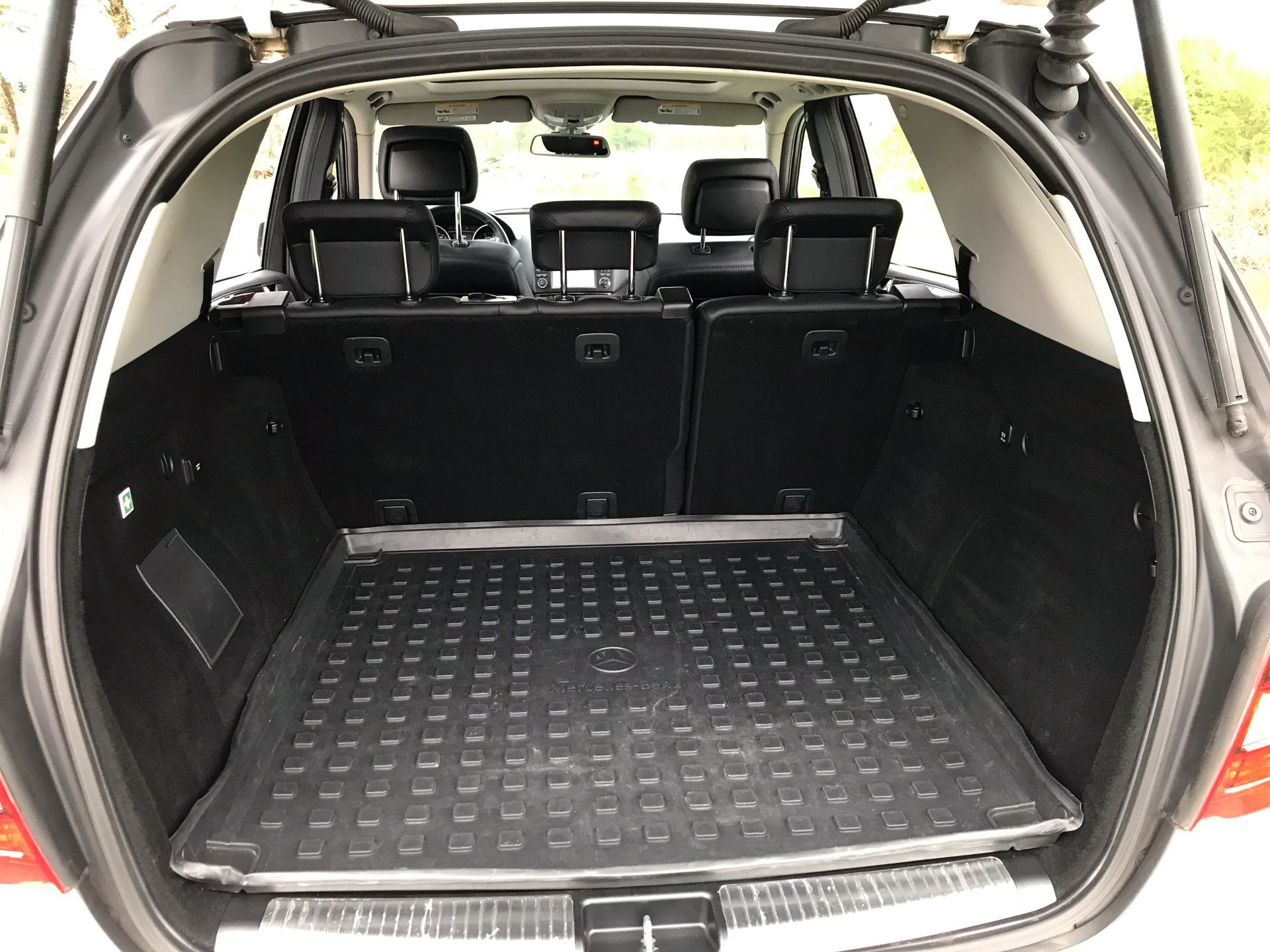 The trunk of a car with a tray in it.